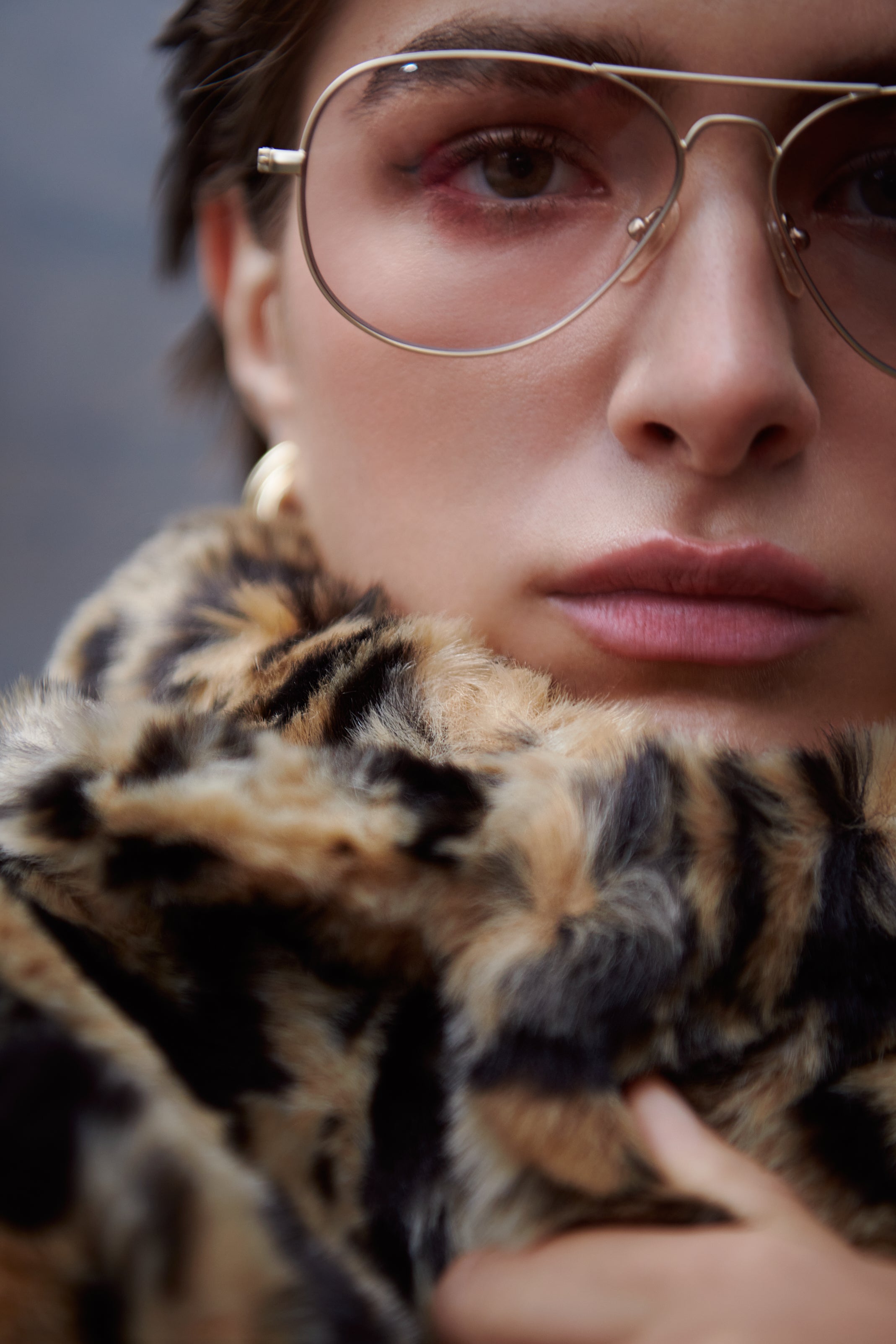 The The Long Song Coat by Unreal Fur accessorized with Mabuhay Matte Gold Reading Glasses and the Florence Earrings by Jenny Bird