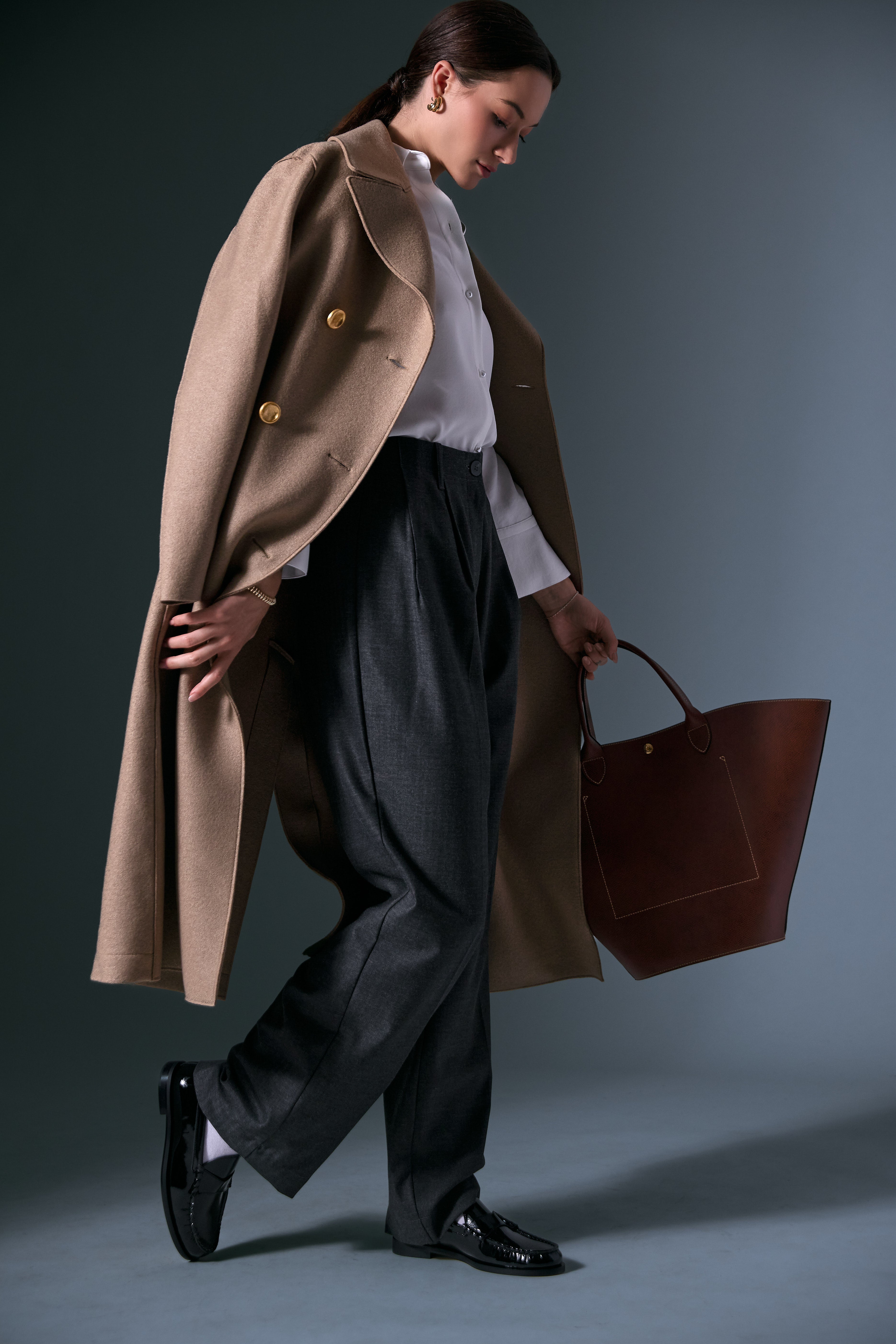 The Military Pressed Wool Coat by Harris Wharf London overtop the Pearl Long-Sleeve Shirt by Vince and the Sorai Trouser by Momoni, styled with the Luca Classic Loafer by Dear Frances, the Épure XL Tote Bag by Longchamp and Jenny Bird Earings & bracelet. 